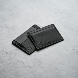 Black leather bifold wallet on a pale surface